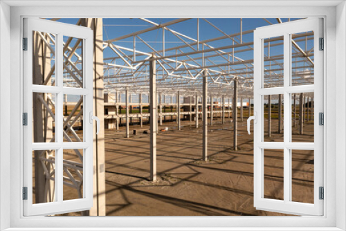 Fototapeta Naklejka Na Ścianę Okno 3D - Drone photography of new warehouse metal frame and construction site under development