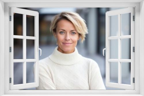 medium shot portrait of a Polish woman in her 40s wearing a cozy sweater against a modern architectural background