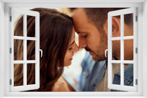 Close-up of two lovers, leaning for a kiss, sharing love, enjoying themselves together.