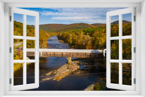 Fototapeta Naklejka Na Ścianę Okno 3D - Covered bridge with fall foliage landscape over river in Dummerston, Vermont New England town during autumn season