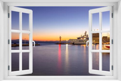 Fototapeta Naklejka Na Ścianę Okno 3D - View of the city embankment in night lighting at dawn. Rhodes.