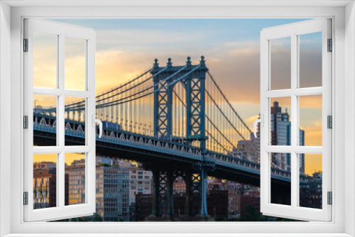 Fototapeta Naklejka Na Ścianę Okno 3D - Manhattan bridge is a giant suspension bridge. .The public transport and vehicles drive on two levels. Connecting Brooklyn with Manhattan. Manhattan bridge is over on the East river In New york city