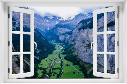 Fototapeta Naklejka Na Ścianę Okno 3D - Lauterbrunnen, a picturesque Swiss village nestled in a pristine valley, is a true natural wonder when viewed from above.