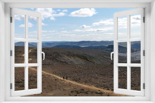 Fototapeta Naklejka Na Ścianę Okno 3D - Panoramic view over lava field with hikers on path near mountain Fagradalsfjall with fissure vent of 2021 in Geldingadalir volcano area to the south of Fagradalsfjall mountain, Iceland