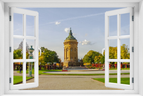 Fototapeta Naklejka Na Ścianę Okno 3D - Mannheim, Germany. Panoramic view over old city water tower at Friedrich square in sunset golden Autumn colors. Cityscape in the historical downtown at sunny day and milky blue sky.