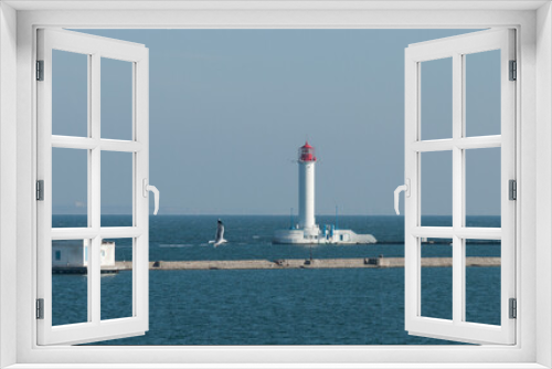 Fototapeta Naklejka Na Ścianę Okno 3D - The Vorontsov lighthouse is located at the end of the Quarantine pier in the port of Odessa on the Black Sea. He is the first to meet and the last to see off all the courts that come to Odessa.