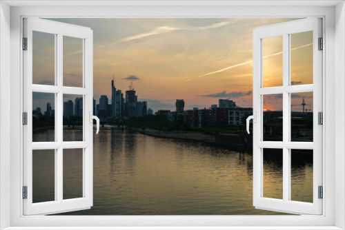 Fototapeta Naklejka Na Ścianę Okno 3D - sunset time in frankfurt city. panorama view above the main river and in the backround the skyline in the evening sky