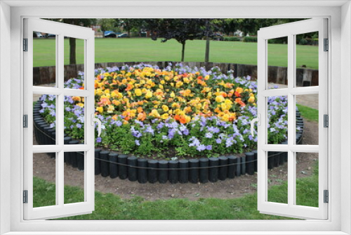 Fototapeta Naklejka Na Ścianę Okno 3D - Large round flowerbed taken at a public park UK