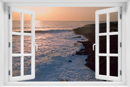 Fototapeta Naklejka Na Ścianę Okno 3D - White waves crashing rocks sunny morning aerial. Sunrise horizon over ocean bay