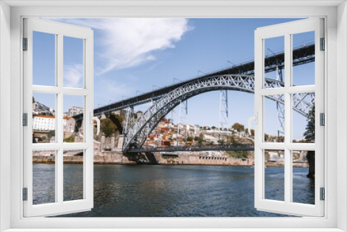 Fototapeta Naklejka Na Ścianę Okno 3D - Stunning view of a bridge stretching over a river in the city of Porto, Portugal