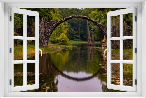 Fototapeta Naklejka Na Ścianę Okno 3D - The Rakotzbrucke, a devil's bridge surrounded by forest
