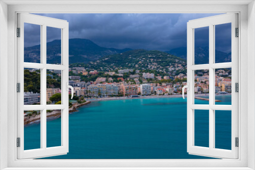 Fototapeta Naklejka Na Ścianę Okno 3D - Aerial view of The French Riviera at Menton, France. Photography was shoot from a drone at a higher altitude from above the bay with the city and the mountains in the background on a stormy weather.