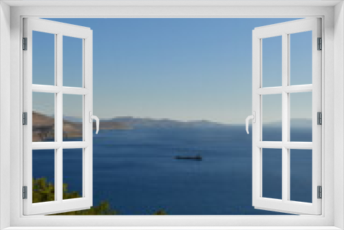 Fototapeta Naklejka Na Ścianę Okno 3D - fright cargo ship on horizon from geek island kalymnos