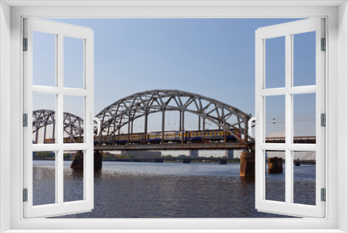 Fototapeta Naklejka Na Ścianę Okno 3D - Train on the bridge over Daugava River. Riga, Latvia