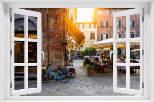 Fototapeta Naklejka Na Ścianę Okno 3D - Old cozy street with tables of restaurant in Lucca, Italy