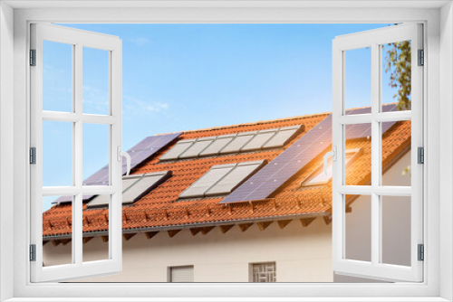 Fototapeta Naklejka Na Ścianę Okno 3D - Solar Panels Roof and Skylights with Blinds Window on Tiled Roof of Private House Close up. Smart House with Solar Energy and Sun Protection.