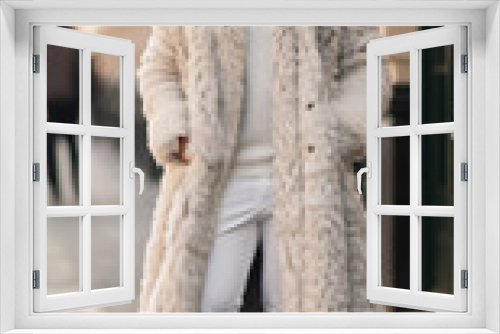 Street style clothing - fashionable man in a white elegant fur coat fashion on the street. for Fashion Concept, Animal Welfare and Faux Fur, Content Blogger
