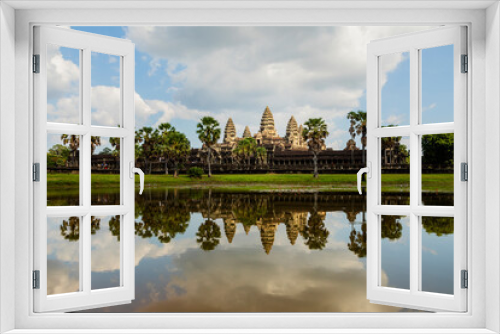 Fototapeta Naklejka Na Ścianę Okno 3D - General view of the famous temple of Angkor Wat, Cambodia, Asia, photographed in the afternoon, and reflected in the water of the outer lagoons surrounding it.