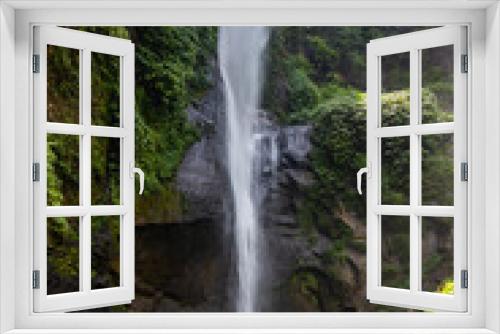 Fototapeta Naklejka Na Ścianę Okno 3D - The Sekumpul Waterfall, a large waterfall in the middle of the jungle that falls into a deep green gorge. Trees and tropical plants at Bali's highest waterfall.