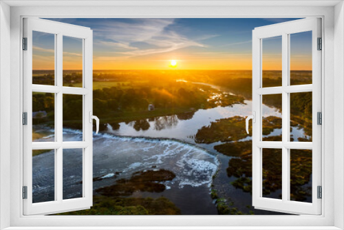 Fototapeta Naklejka Na Ścianę Okno 3D - Birds eye view of  Venta Rapid waterfall, the widest waterfall in Europe and long brick bridge, during beautiful sunrise