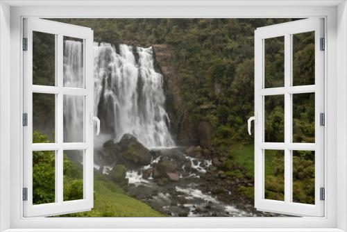 Fototapeta Naklejka Na Ścianę Okno 3D - Marokopa Falls in thick forest in the Waitomo area of the Waikato Region, New Zealand. Here the Marokopa River cascades over the undercut greywacke basement rock. 