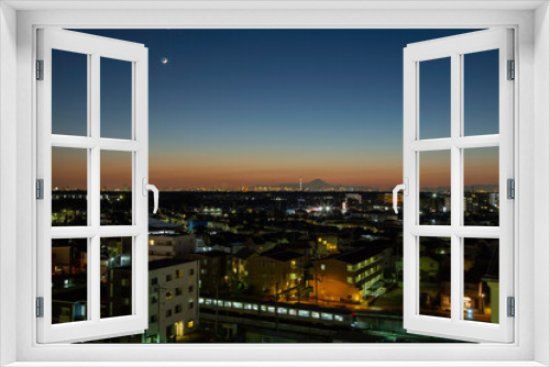 Fototapeta Naklejka Na Ścianę Okno 3D - Enjoy views of Mount Fuji in the evening from the top of an office building in Kamagaya, Chiba Prefecture, Japan. You'll also be able to see the Tokyo Skytree in Tokyo.