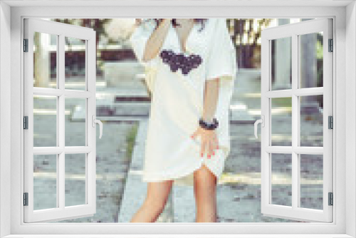 Woman, model of fashion, wearing white dress with curly hair