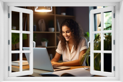 Happy young woman using laptop sitting at desk writing notes while watching webinar, studying online, looking at pc screen learning web classes or having virtual call meeting remote working from home