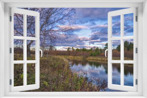 Fototapeta Naklejka Na Ścianę Okno 3D - Autumn landscape with riverbank at sunset. Wonderful nature, beautiful natural background. Sky with clouds is reflected in the water.