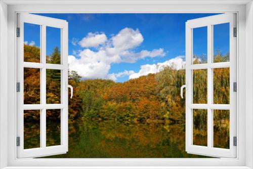Fototapeta Naklejka Na Ścianę Okno 3D - Beautiful autumn landscape by the Vida lake in Apuseni Mountains, Romania. Trees in colorful foliage and forested in the Occidental Carpathians reflecting in the water surface.