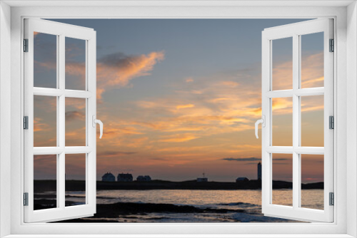 Fototapeta Naklejka Na Ścianę Okno 3D - Kjolnes lighthouse on the rocky shores of Barents Sea in soft and colorful evening light after sunset