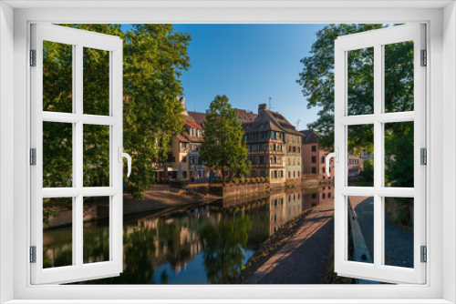 Fototapeta Naklejka Na Ścianę Okno 3D - Strasbourg, France. Ancient houses of the Petite France district on the embankment of the Ille River in the early morning.