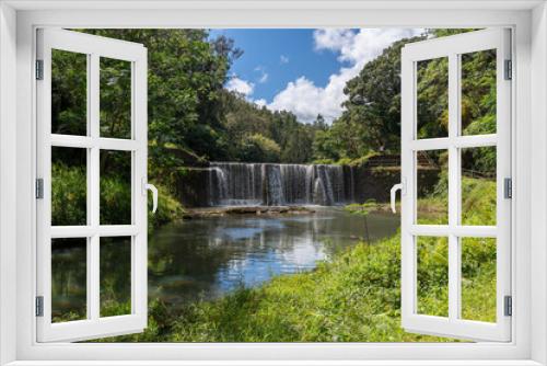 Fototapeta Naklejka Na Ścianę Okno 3D - A stone dam with beautiful waterfall in Kauai, Hawaii, United States.
