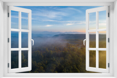 Fototapeta Naklejka Na Ścianę Okno 3D - Aerial view of morning sunrise of tropical rainforest at dawn with misty and foggy cloud during summer for outdoor mountain valley landscape