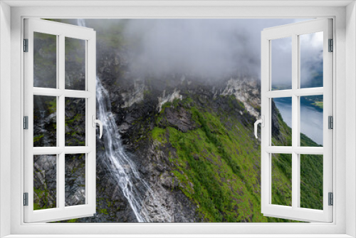 Fototapeta Naklejka Na Ścianę Okno 3D - Aerial view of waterfall flowing down cliff into Fjord in Norway