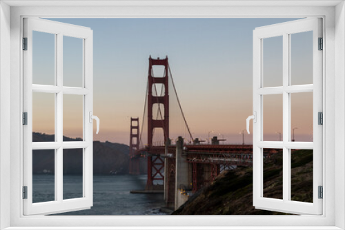 Fototapeta Naklejka Na Ścianę Okno 3D - golden gate bridge at sunset, image shows the 2737 meter long bridge built in 1937 on a warm evening with clear skies showing a array of sunset colours, taken october 2023