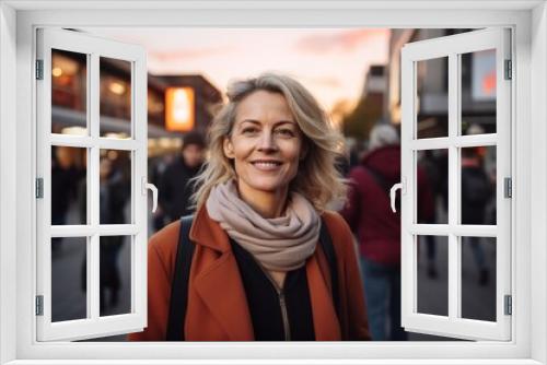 Portrait of smiling middle-aged woman in a city street.