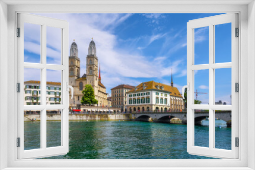 View of the Wasserkirche, Grossmunster and Limmat river with unknown people. Canton of Zurich, Switzerland. A walk through the city on a sunny day