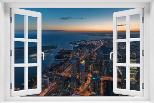 Fototapeta Naklejka Na Ścianę Okno 3D - The view of downtown Toronto skyline skyscrapers from the top of CN tower. Lake at dawn, city light bright night long exposure aerial above view