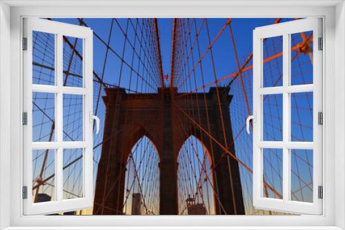 Fototapeta Naklejka Na Ścianę Okno 3D -  Brooklyn Bridge is one of the oldest suspension bridges in the US. Completed in 1883, it connects the New York City boroughs of Manhattan and Brooklyn by spanning the East 