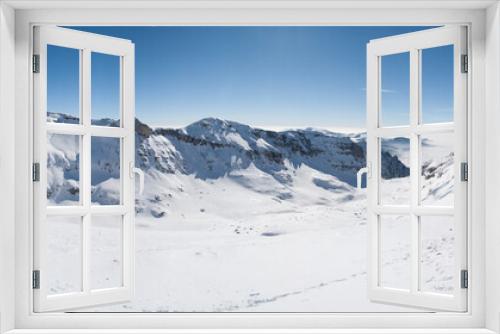 Fototapeta Naklejka Na Ścianę Okno 3D - Snowy peaks glisten against a vast blue canopy