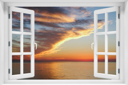 Fototapeta Naklejka Na Ścianę Okno 3D - orange cloudy sunset sky view from the sea
