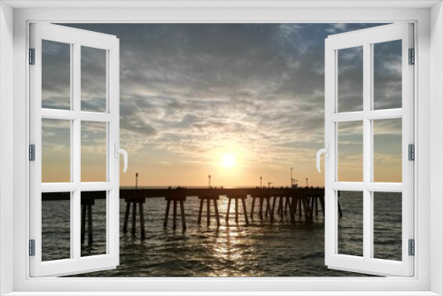 Fototapeta Naklejka Na Ścianę Okno 3D - Beautiful sunset over a pier in the sea.