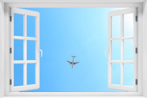 Fototapeta Naklejka Na Ścianę Okno 3D - Single plane silhouette flying across a clear blue sky day