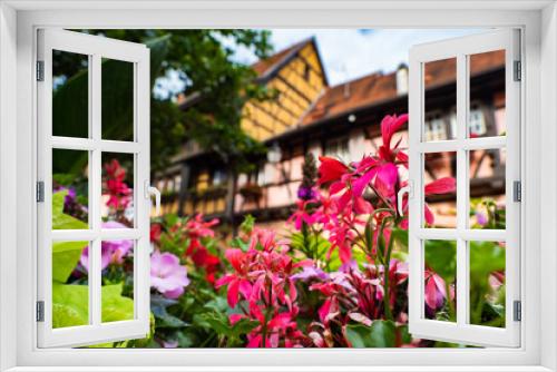 Fototapeta Naklejka Na Ścianę Okno 3D - the colorful half timbered building in the streets of the beautiful Alsace village Riquewihr