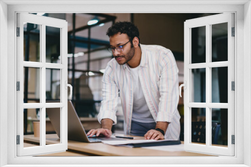 Focused man using laptop in office