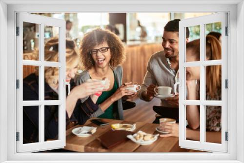 Group of Happy friends having coffee together in cafe or bar