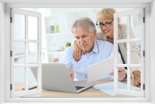 Senior couple doing the income tax declaration online