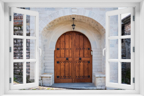 Double wooden gates. Entrance of house with beautiful old wooden door. Traditional Mediterranean architecture.