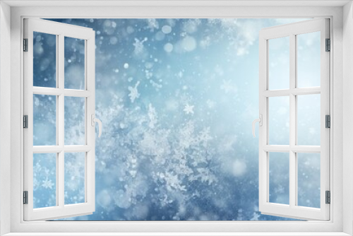 Winter snowy blurred defocused blue background with copy space. Flakes of snow fall. Festive Christmas and New year background